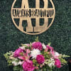 Pink and white floral arrangement in a silver container