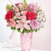 Pink and red mixed bouquet in a glass vase