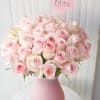 Pink rose bouquet in a matte pink vase with a heart-shaped love pick