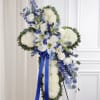 A timeless all-white floral cross designed with elegance and reverence, accented by
