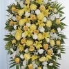 A radiant yellow and white standing spray designed to bring warmth, comfort