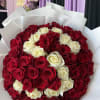 Bouquet of red and white roses wrapped in white paper