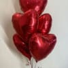 Cluster of red heart-shaped balloons tied together