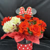 Red roses and white hydrangeas in a polka-dot gift box with a bow topper