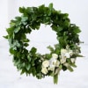 Green floral wreath with white roses and orchids