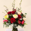 A lush cluster of red, cream, and blush roses creates an immediately