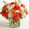 Orange and white mixed bouquet in a clear glass vase