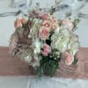 Blush roses and white hydrangeas arranged in a low bouquet