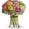 Mixed bouquet of roses, gerbera daisies, and hydrangeas in a glass vase