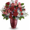 Red roses and pink alstroemeria in a red vase