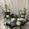 Floral wreath with white roses, blue flowers, and a gold "Beloved Dad" sign