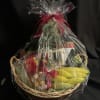 Gift basket with bananas, chocolates, and packaged snacks wrapped in clear cellophane
