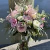 Pink and white bouquet of roses and ranunculus with greenery