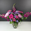 Pink and purple mixed bouquet in a clear glass vase
