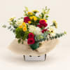 Bouquet of red and yellow roses with white daisies in a vase