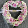 Heart-shaped floral wreath with pink roses and gerbera daisies