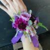 Purple and pink wrist corsage with ribbon and rhinestone accents