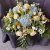 Large bouquet of white and blue flowers with yellow accents