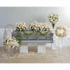 White floral funeral casket spray with matching wreath and standing arrangements