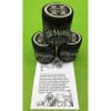 Three black jars of healing salve stacked on a green background with a product card below.