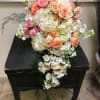 Cascade bouquet of pink and peach roses with white hydrangeas