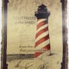 Decorative woven wall hanging with a lighthouse and printed text
