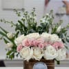 White and blush roses arranged in a wooden box