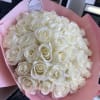 Bouquet of white roses wrapped in pink paper