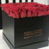 Red roses arranged in a black square box