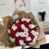 Large bouquet of red and white roses wrapped in brown paper