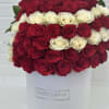Red and white roses arranged in a white hat box