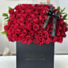 Large box of red roses with a black ribbon bow