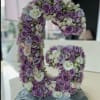 Floral arrangement shaped like the number 5 with purple and white roses