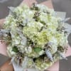 Bouquet of pale green and white hydrangeas with small filler flowers