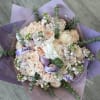 Bouquet of pale peach and white roses with eucalyptus in lavender wrap