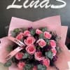 Pink rose bouquet with purple accents and eucalyptus in pink wrap