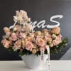 Blush roses and sweet peas in a white textured vase