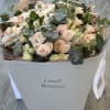 Bouquet of pale pink roses and eucalyptus in a white box