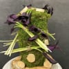 Purple calla lilies arranged on a moss-covered wooden base