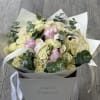 A charming bouquet featuring a blend of classic roses, delicate spray roses