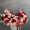 Large bouquet of red and blush roses in a silver vase