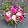 Picture vibrant pink peonies and hot pink garden roses mingling amidst the
