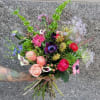 This exquisite bouquet features elegant anemones, their delicate petals and dark centers