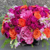 The Ruby Glow Arrangement is a stunning celebration of vibrant colors that