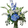 Blue and white floral arrangement in a clear glass vase
