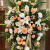Large floral standing spray with white lilies, peach roses, and white chrysanthemums