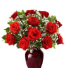 A generous cluster of rich red roses gathered into a rounded, classic