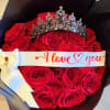 Red roses in black wrap with a jeweled crown and "I love you" ribbon