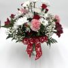 Bouquet of white daisies and pink carnations with a red heart ribbon