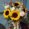 A delightful blend of medium dark center Sunflowers with&nbsp; premium White Roses